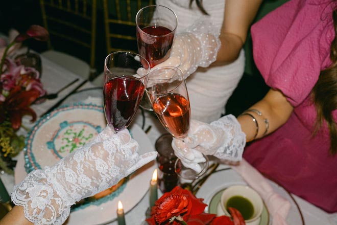 The bridal party cheers with rose at their vintage bridal tea party.