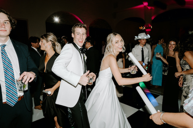 The bride and groom dancing with guests during the reception. 