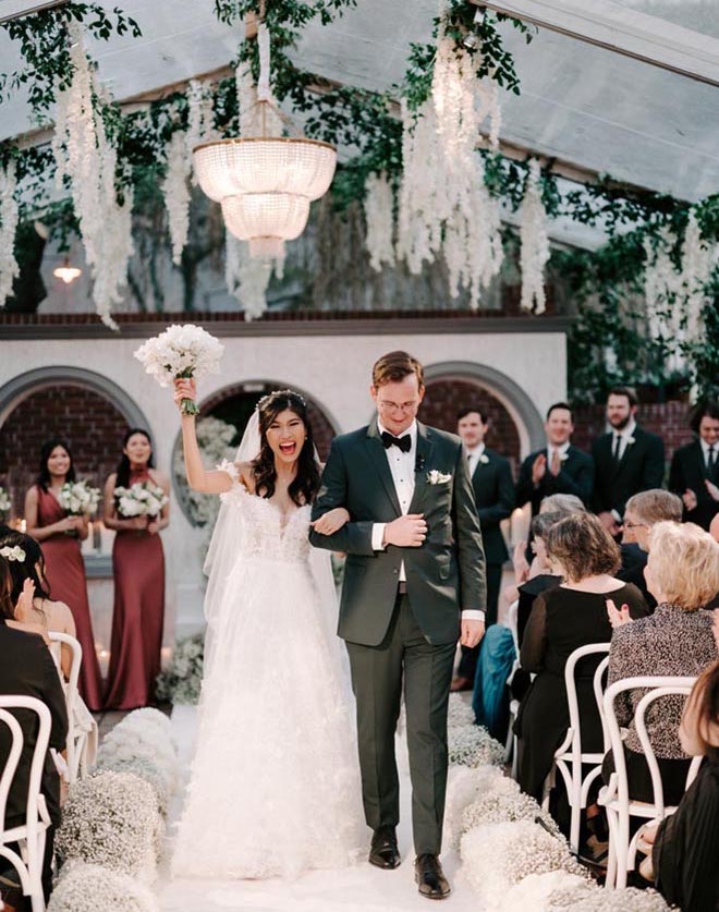 The bride and groom celebrate walking down the aisle leaving their wedding ceremony.