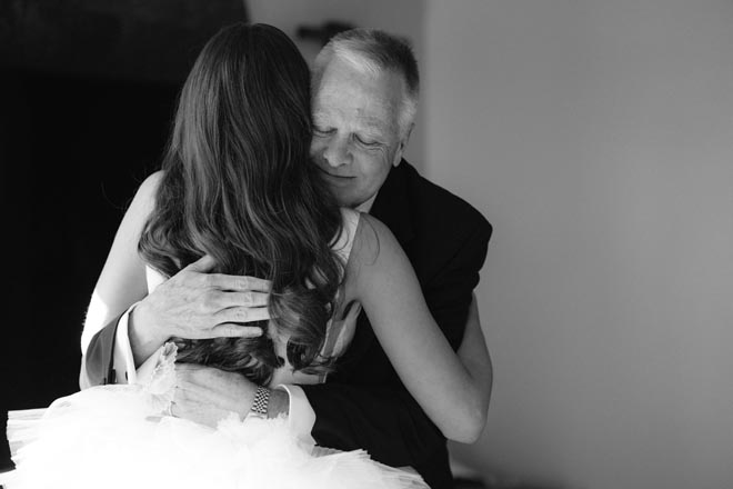 The bride and her father share a hug before walking down the aisle. 