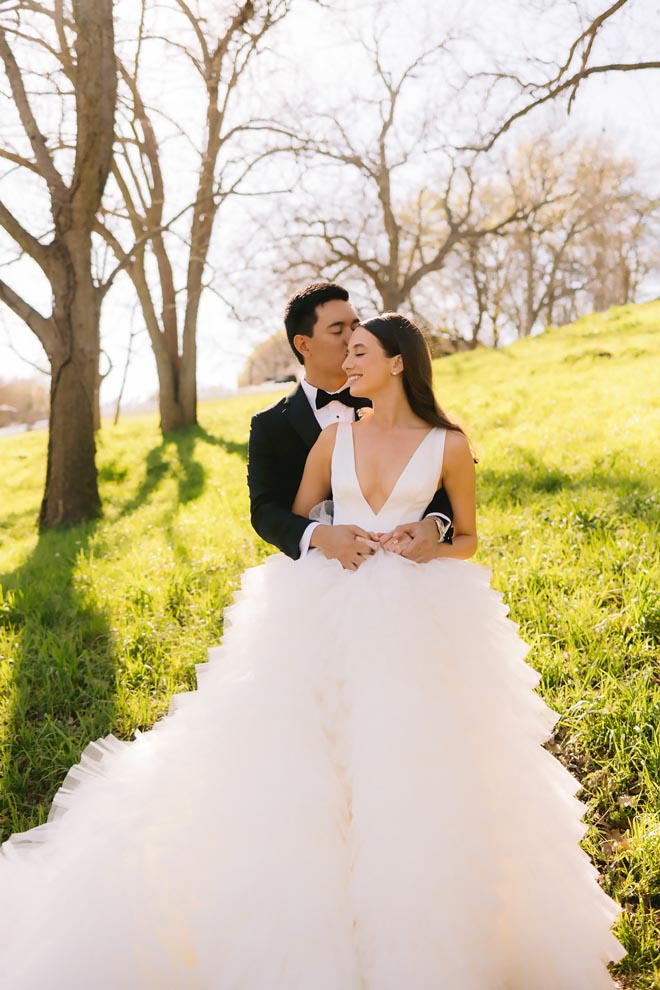 The bride and groom pose for their sun-kissed al fresco wedding by the Colorado River.