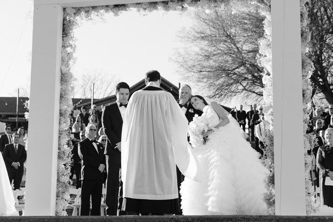 The father of the bride escorts his daughter down the aisle to the altar. 