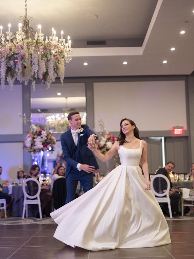 The bride and groom share their first dance on the dance floor in the Omni Houston Hotel's ballroom.