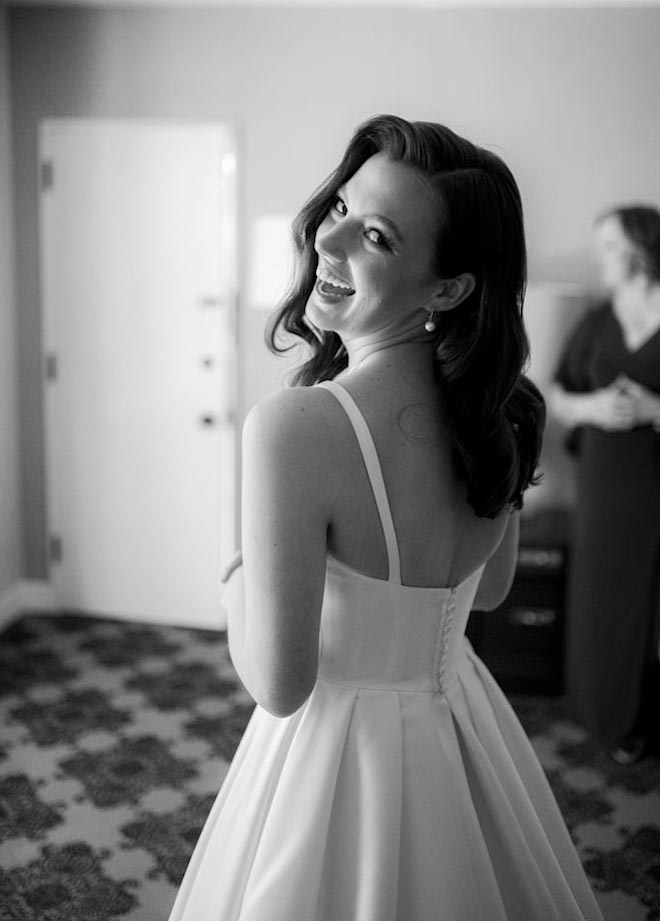 The bride looks over her shoulder while getting ready for her ballroom wedding at the Omni Houston Hotel. 