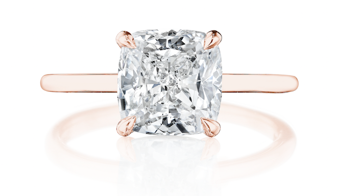 A rose gold band with a princess cut diamond. 