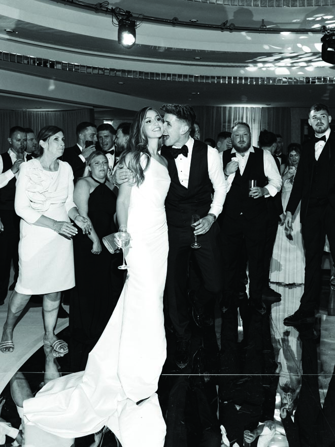 The bride and groom embrace at their storybook wedding in England. 