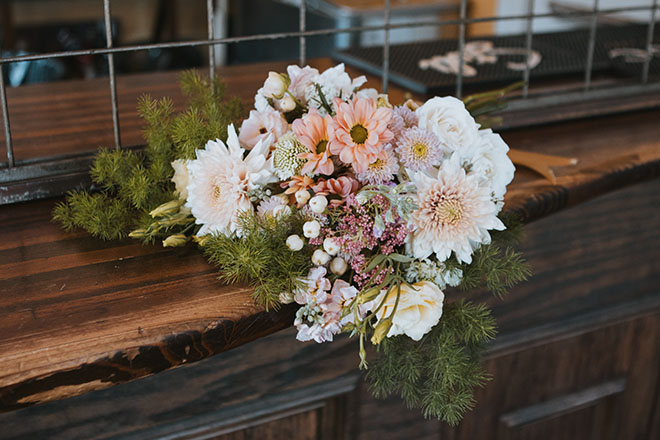 AvantGarden created wedding bouquets with neutral colored florals for the couple's art nouveau wedding.