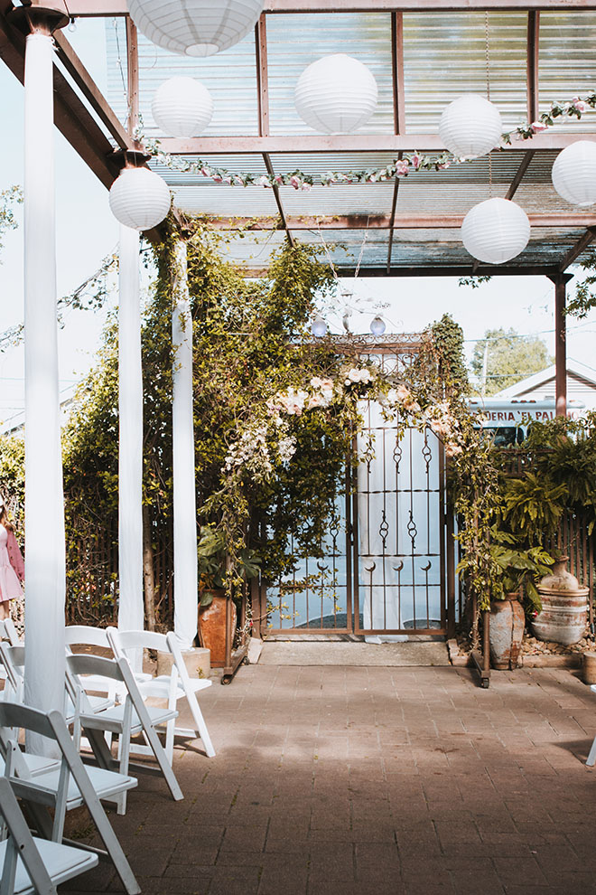 Neutral colors and greenery decorate the outdoor patio at the Houston wedding venue, AvantGarden.