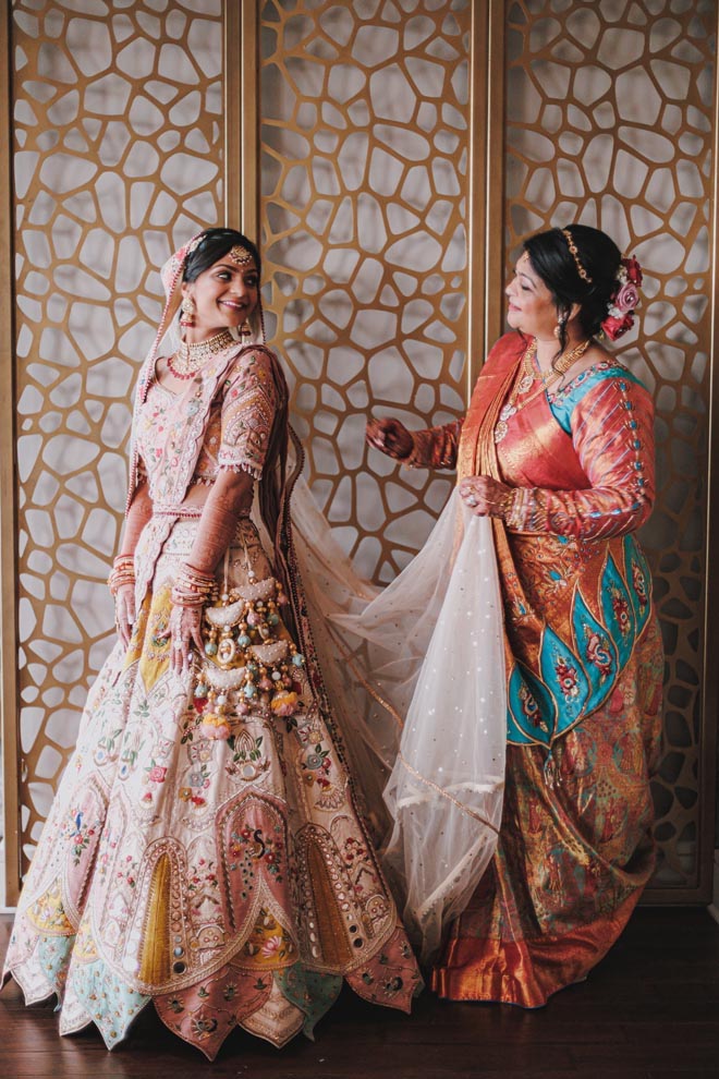 The mother of the bride helps her daughter get ready for her traditional Hindu ceremony.