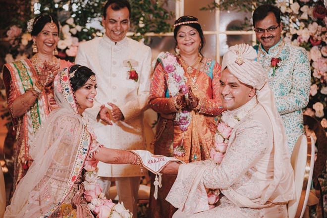 The bride and groom laugh during their traditional Hindu ceremony.