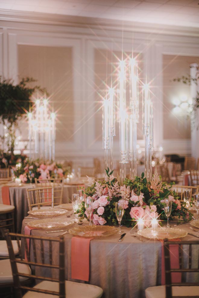 Pastel flowers, greenery and candelabras decorate the reception tables.