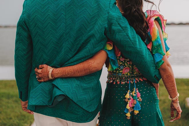 The bride and groom embrace each other during their Mehndi ceremony.