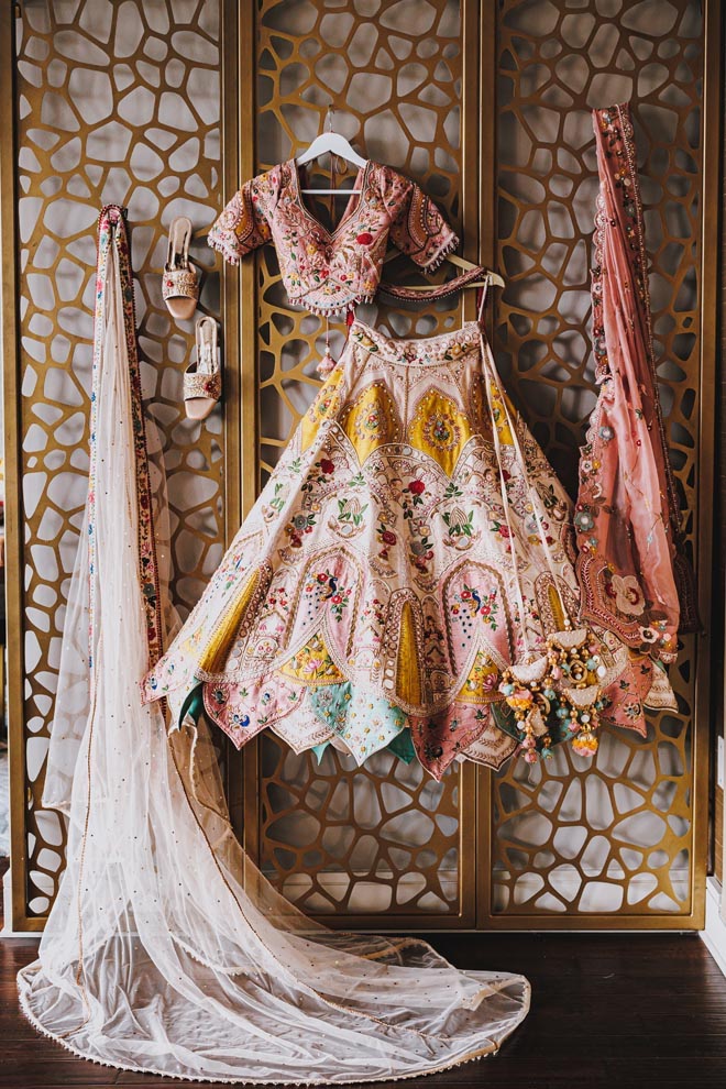 The brides traditional Indian wedding attire hang up on the wall at a Houston wedding venue.