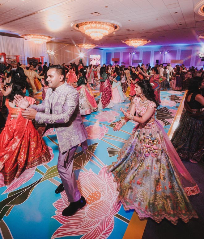 The bride and groom dance around The Westin Galleria Houston's ballroom at their Sangeet.