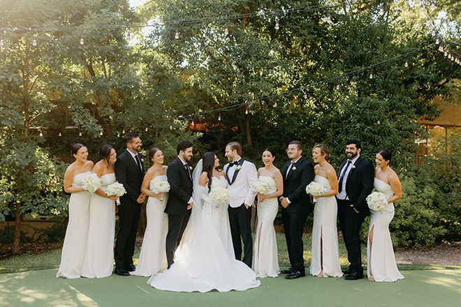 The bride and groom posing with their wedding party at The Houstonian Hotel Club & Spa. 