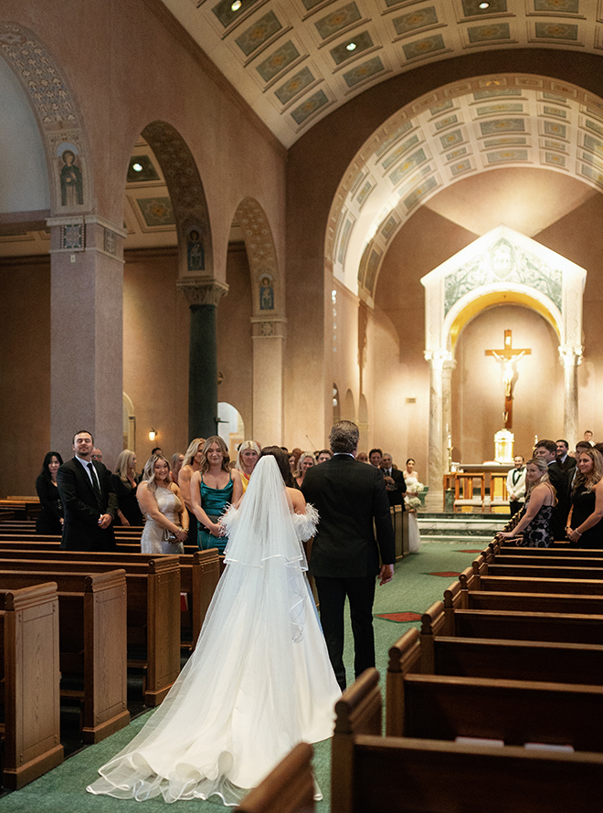 The bride and her father walking down the aisle for the traditional wedding ceremony. 