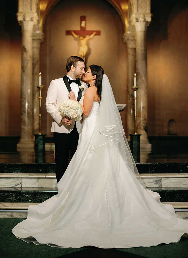 The bride and groom smiling at each other in the church where they had a traditional wedding ceremony. 