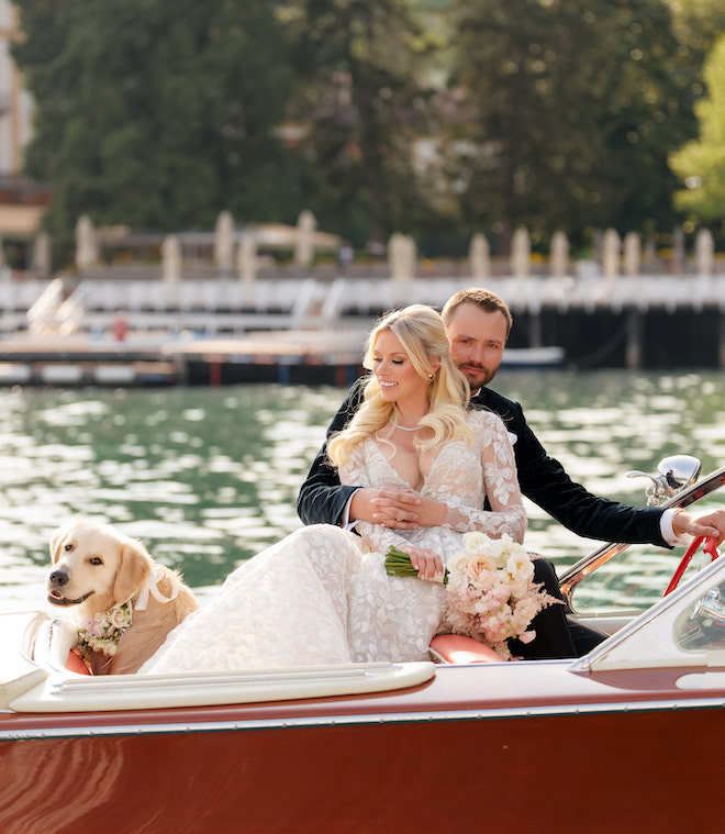 The bride, groom and golden retriever on a red boat on Lake Como, Italy. 