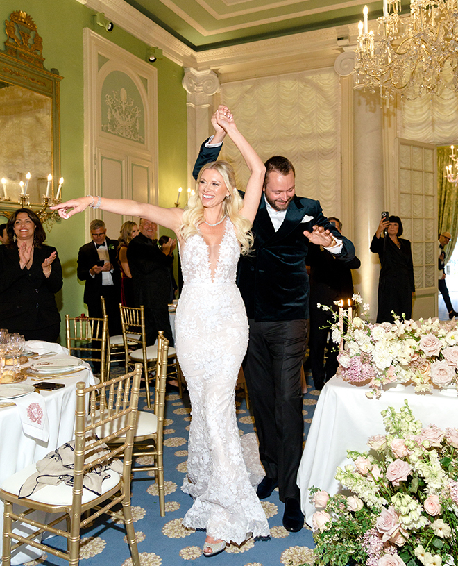 The bride and groom dancing while entering the ballroom. 