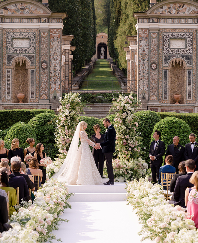 The bride and groom holding hands at the altar. 