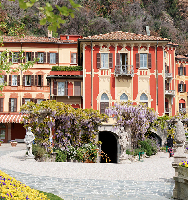 A red and yellow building, known as Villa D'este in Lake Como. 