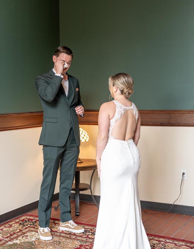 The groom cries during his first look with the bride.