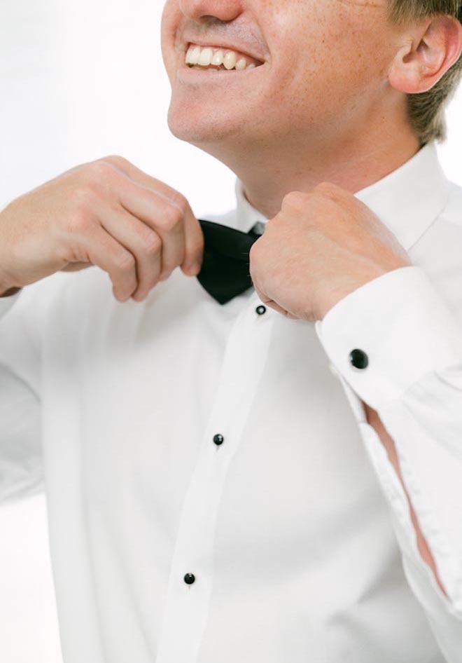 The groom gets ready for his light and airy wedding in Galveston.