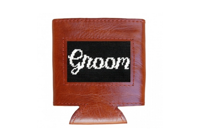 A needlepoint can cooler that says the word Groom.