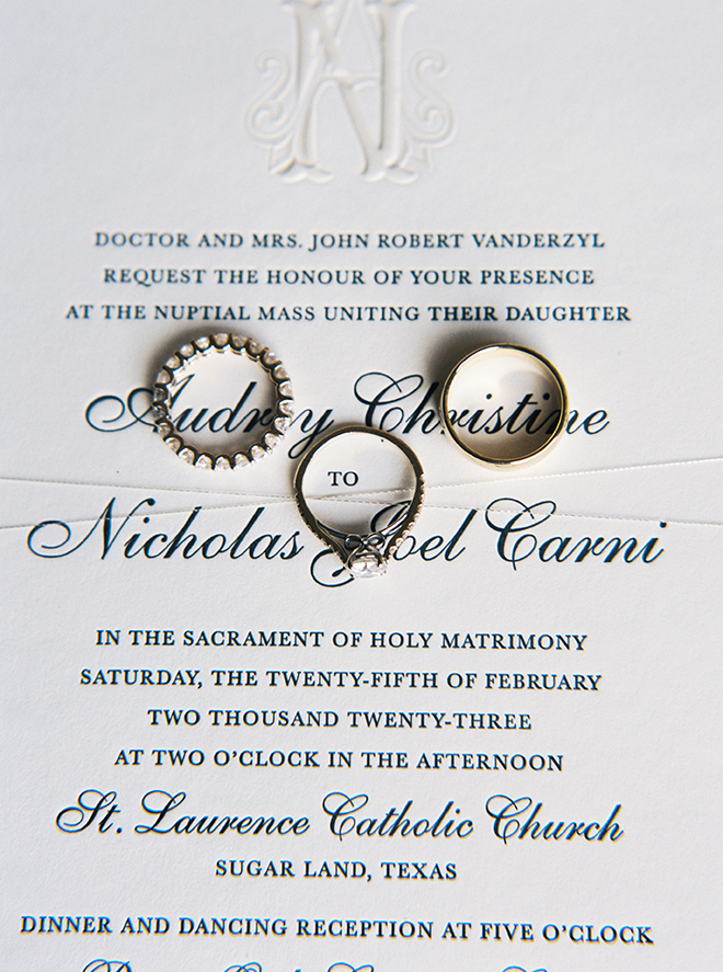 An black and white invitation suite from Bering's with three rings on it. 