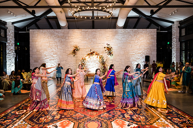 Women in Lehengas dancing in the Hill Country pavilion at Omni Barton Creek Resort & Spa. 