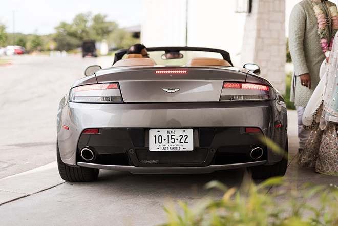 A gray sports car with a license plate that says "10-15-22 Just Married"