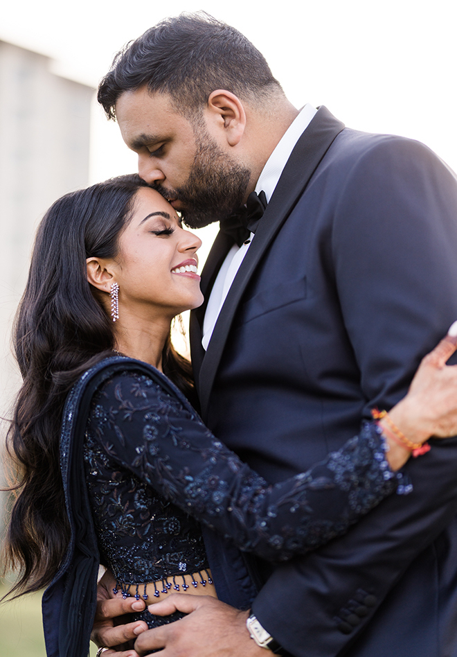 The groom kissing the bride's forehead.