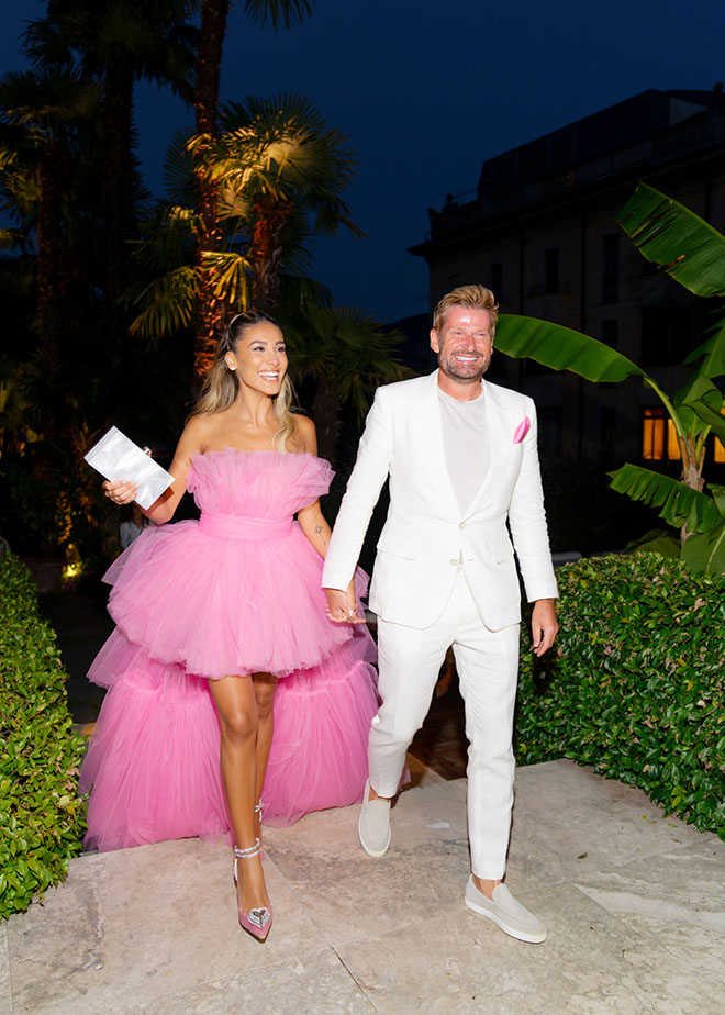 The bride and groom walk into their chic welcome dinner in Lake Como, Italy.