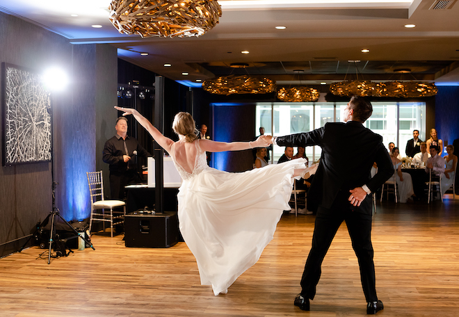 The bride and groom do a choreographed dance in the ballroom.