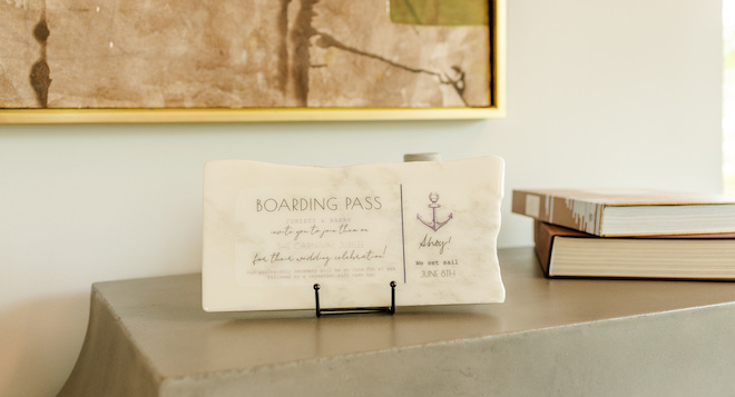 A rectangle shaped marble plaque with the details of plane ticket informations. 