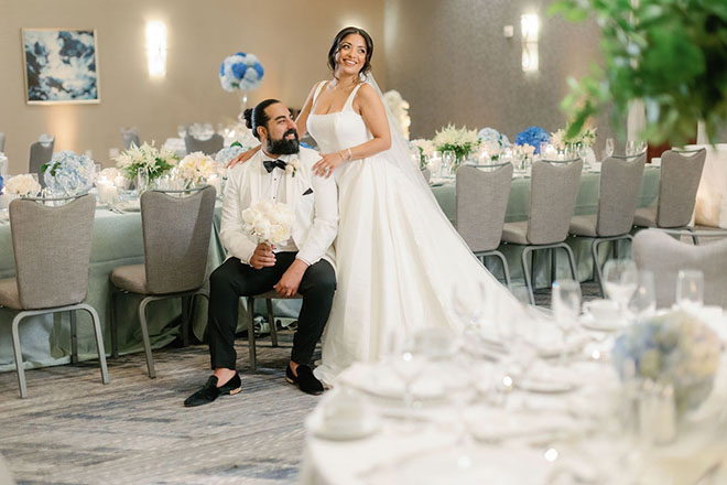 The couple pose in the ballroom of the JW Marriott Houston by The Galleria for the blue-inspired wedding editorial.