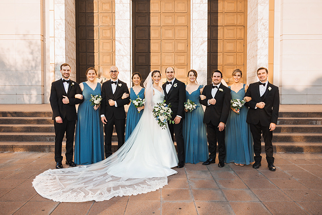 The bridal party poses for a photo all together outside of the chapel.