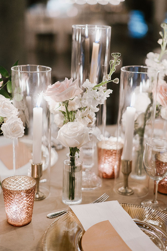 Champagne and copper accents decorate the tables at the wedding reception.