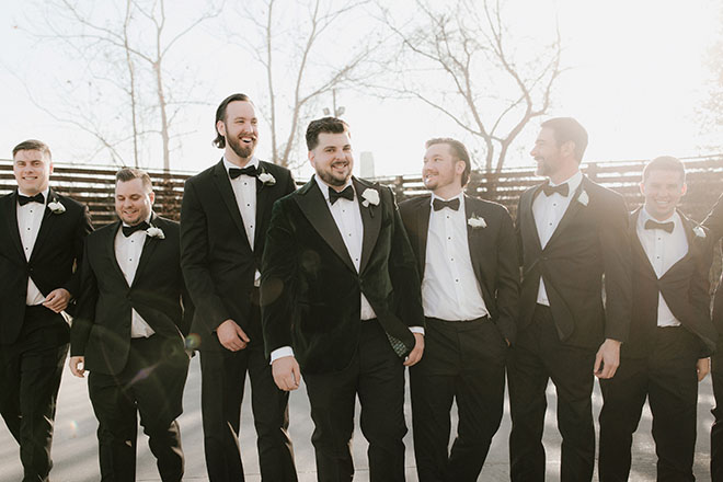 The groom and his groomsmen stand outside their wedding venue in Houston.