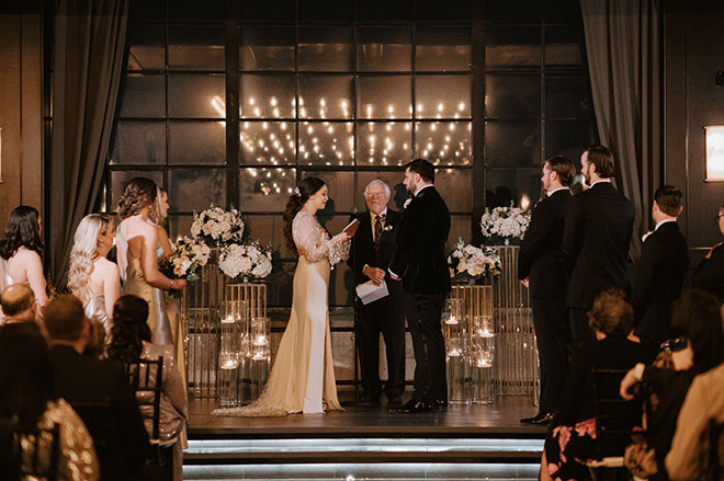 The bride and groom exchange vows at their champagne and copper wedding in Houston.