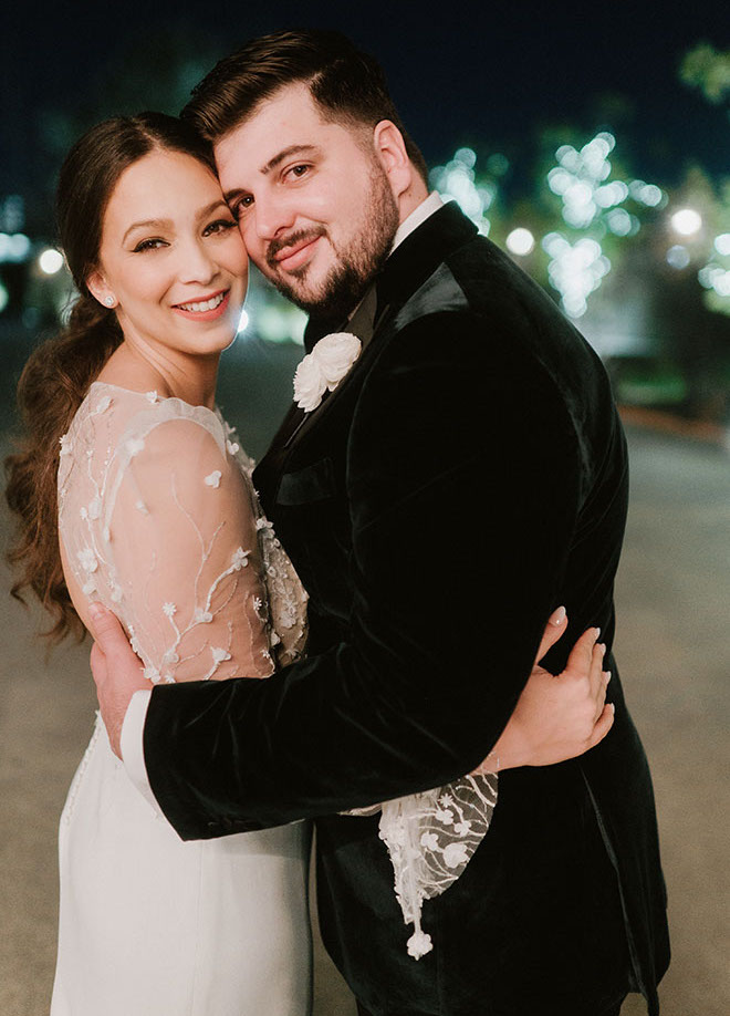 The bride and groom smile outside of The Astorian.