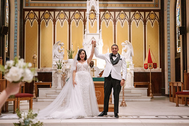 The bride and groom celebrate on the altar after exchanging vows at their wedding ceremony.