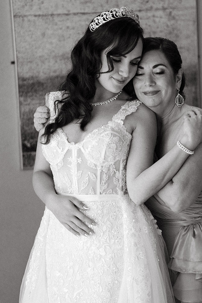 The bride hugs her mom as she gets ready for her traditional church ceremony in Galveston, Texas.