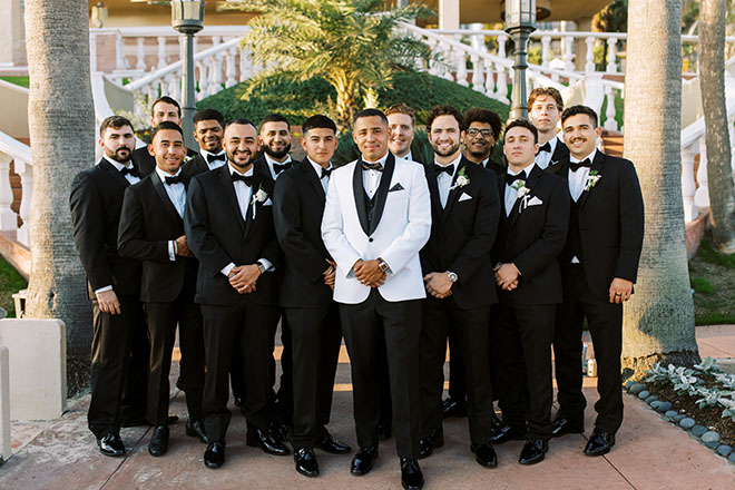 The groom and his groomsmen stand in front of The San Luis Resort, Spa and Conference Center in Galveston, Texas.