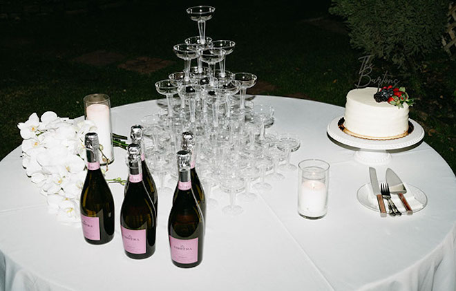 A Champagne tower and chantilly cake are served at the wedding reception.