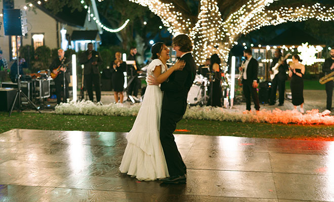 The bride and groom smile as they take the dance floor for their first dance. 