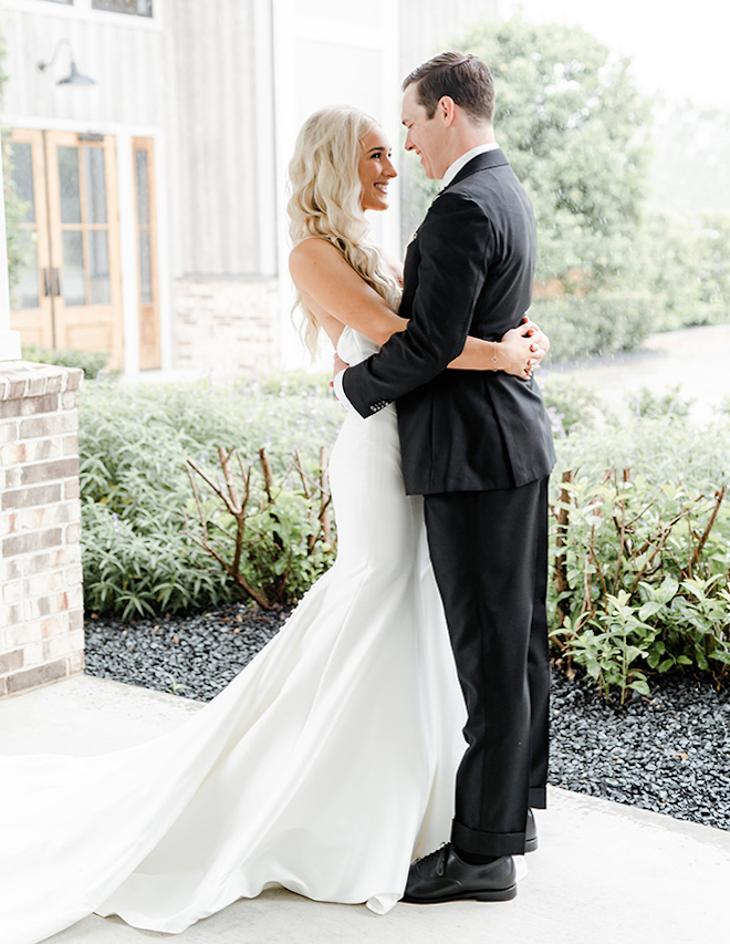 Bride and groom lock eyes as they take photos infront of the venue. 