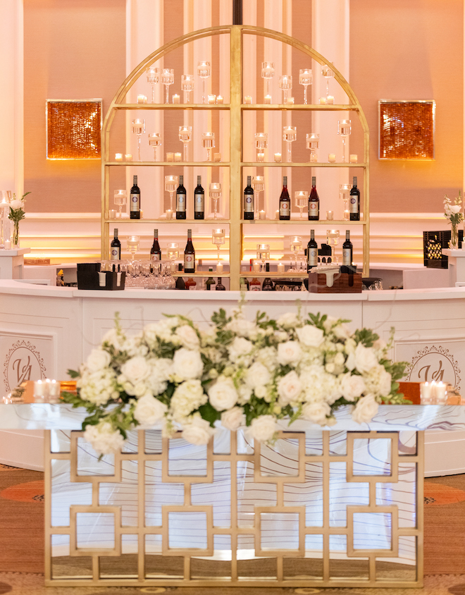 The bar at the reception with candles and champagne bottles. 